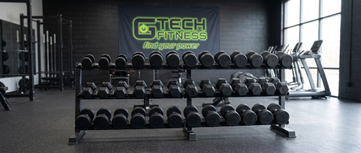 Commercial Dumbbells in Gym Commercial dumbbell rack with rubber hex and round dumbbells in a gym setting